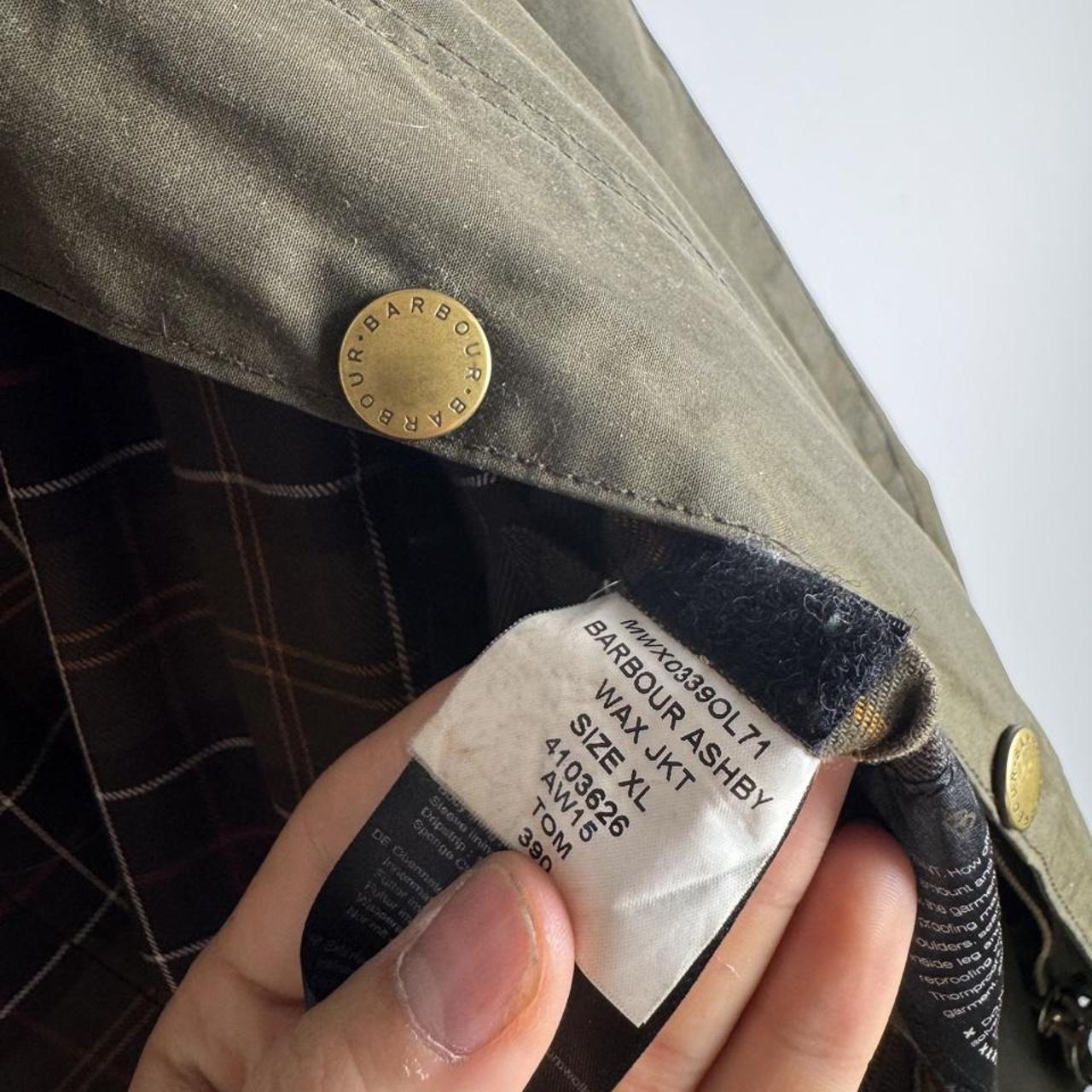 Barbour green wax jacket with logo, classic design, and durable material.