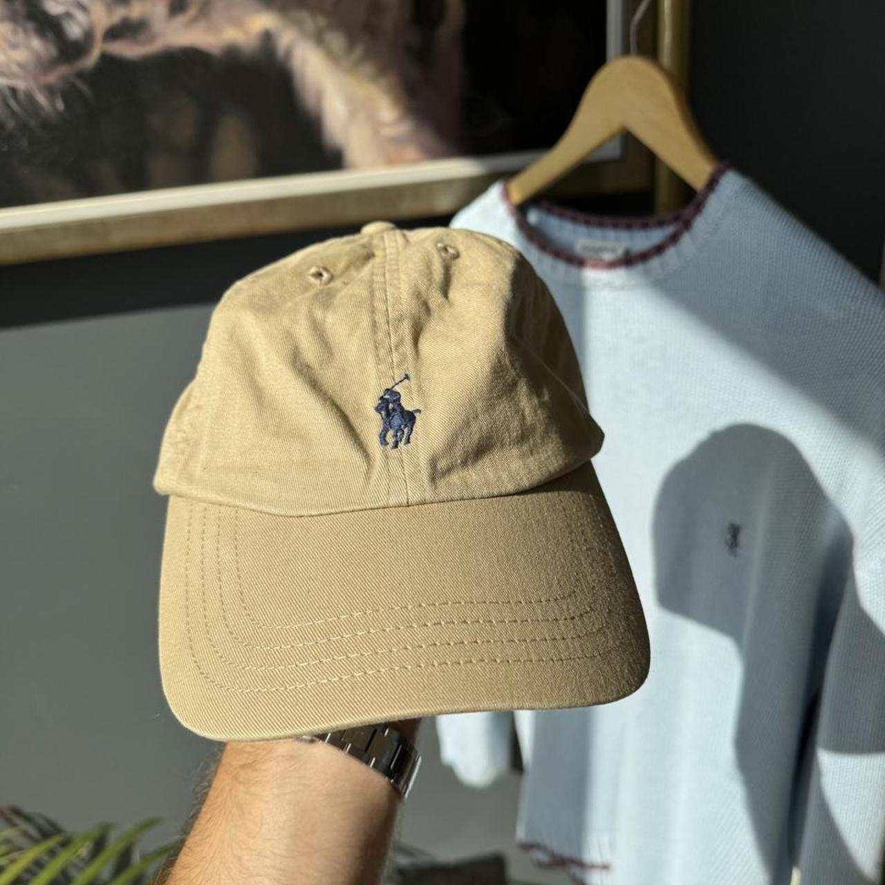 Polo Ralph Lauren beige cap with embroidered pony logo and adjustable strap.