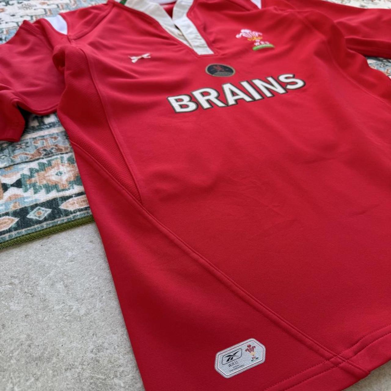 Reebok men's polo shirt red with Wales Rugby logo and slim fit design.