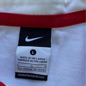 Nike black and white rugby polo shirt with England logo and striped pattern.