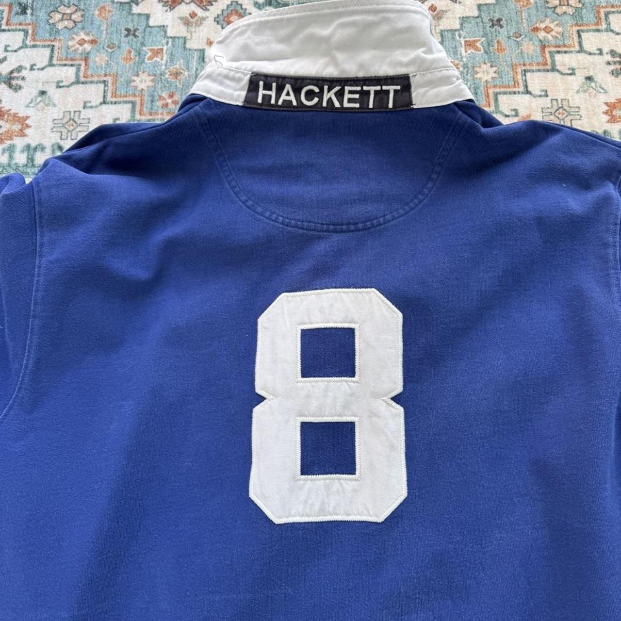 Hackett cream rugby polo with embroidered spellout logo and thick cotton material.