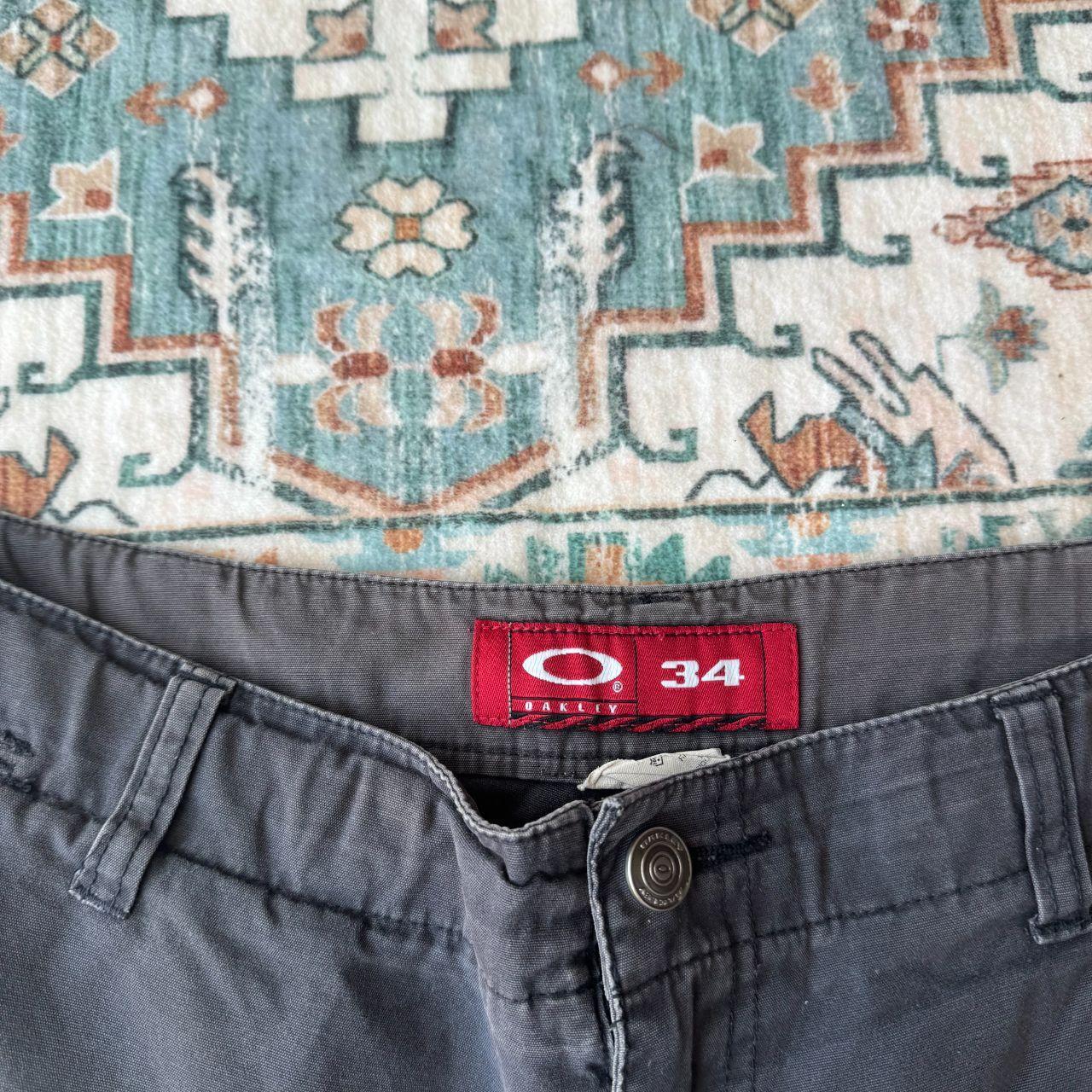 Oakley black cargo shorts with embroidered logo and tactical pockets.