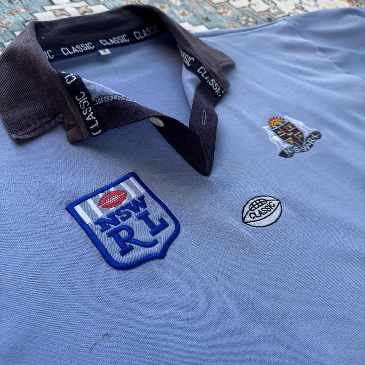 NSW Rugby League blue polo shirt with embroidered logo and vintage 1990s design.