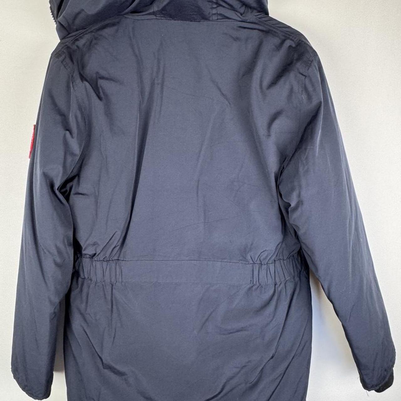 Canada Goose navy parka jacket with logo patch and fur-lined hood.