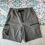 Carhartt WIP olive green cargo shorts with multiple pockets and logo patch.