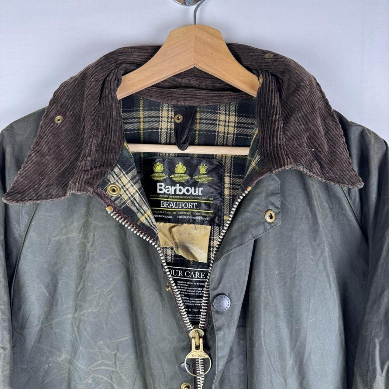 Barbour green waxed Beaufort jacket with attached hood and classic logo detail.