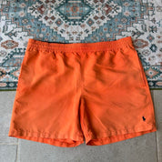 Polo Ralph Lauren orange swim trunks with iconic embroidered logo and lightweight fabric.