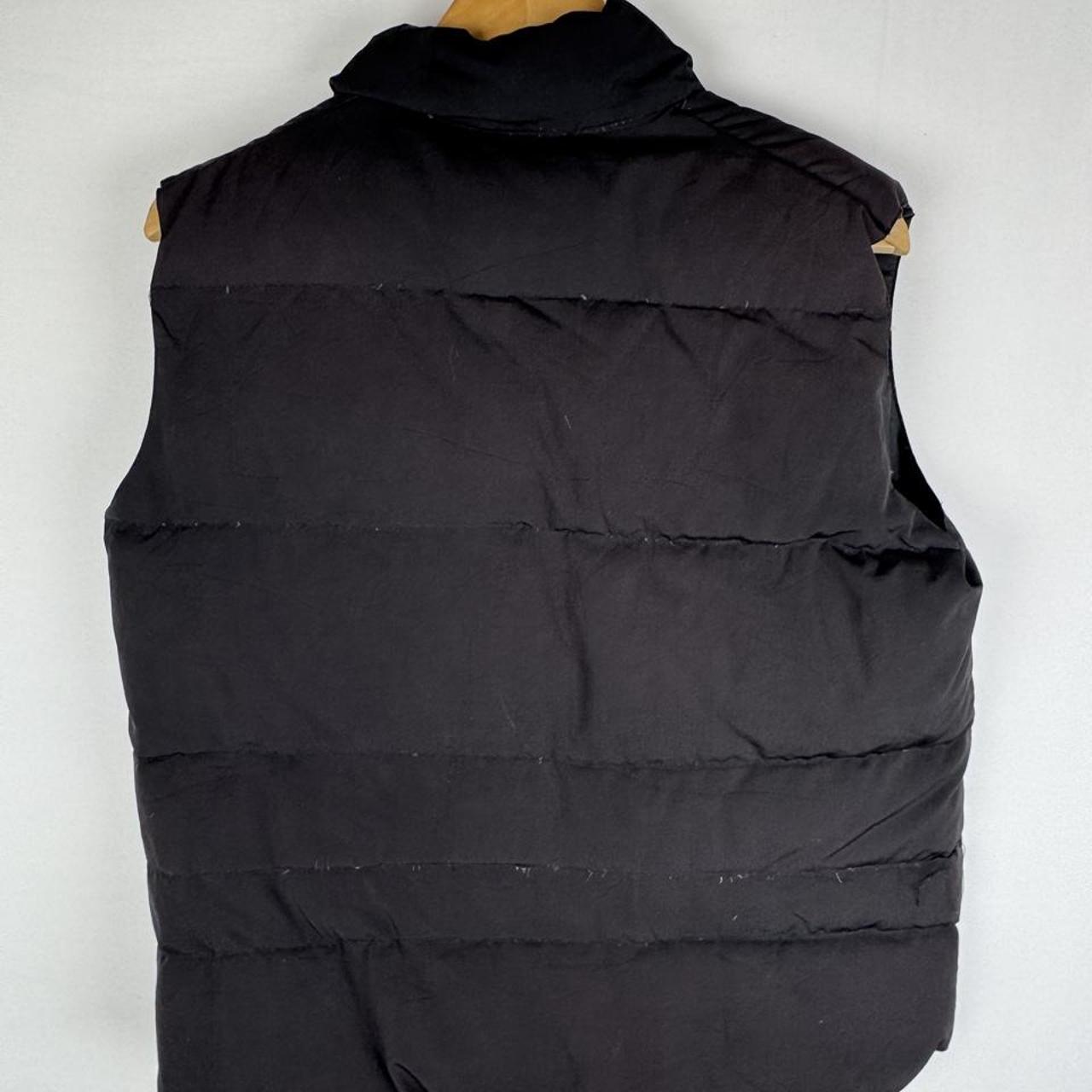 Canada Goose black down filled gilet with logo patch and zip pockets.