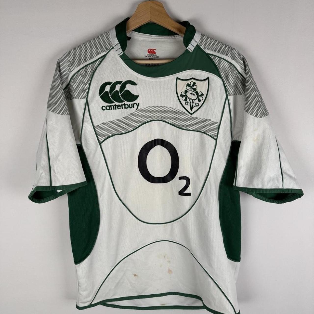 Canterbury green rugby shirt with embroidered Ireland logo and classic collar design.