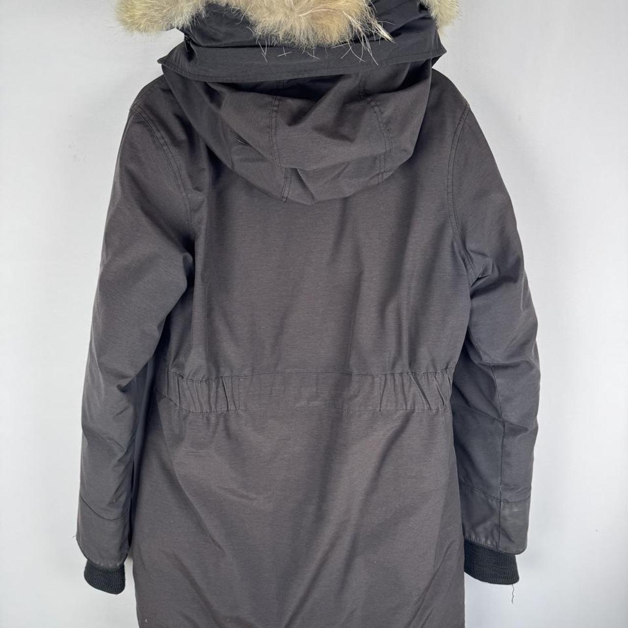 Canada Goose cream parka jacket with logo patch and slightly faded finish.