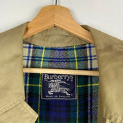 Burberry khaki trench coat with plaid lining and classic logo detail.