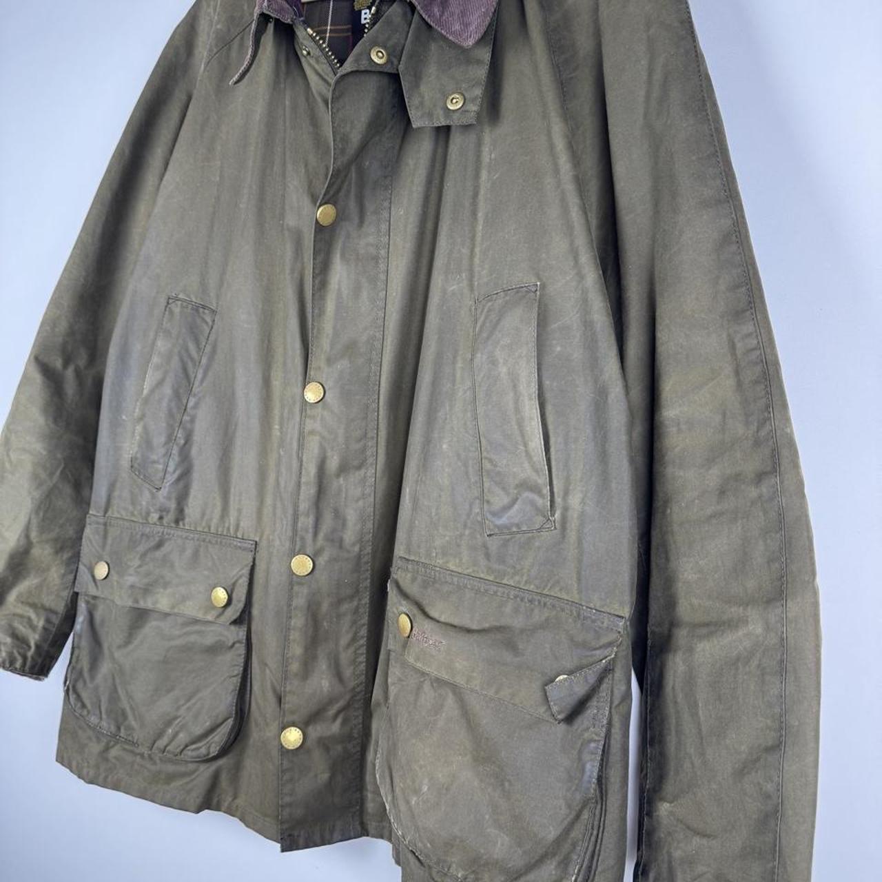 Barbour green wax jacket with logo, classic design, and durable material.