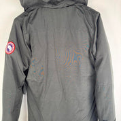 Canada Goose black parka jacket, medium size, features logo patch and sleek design.