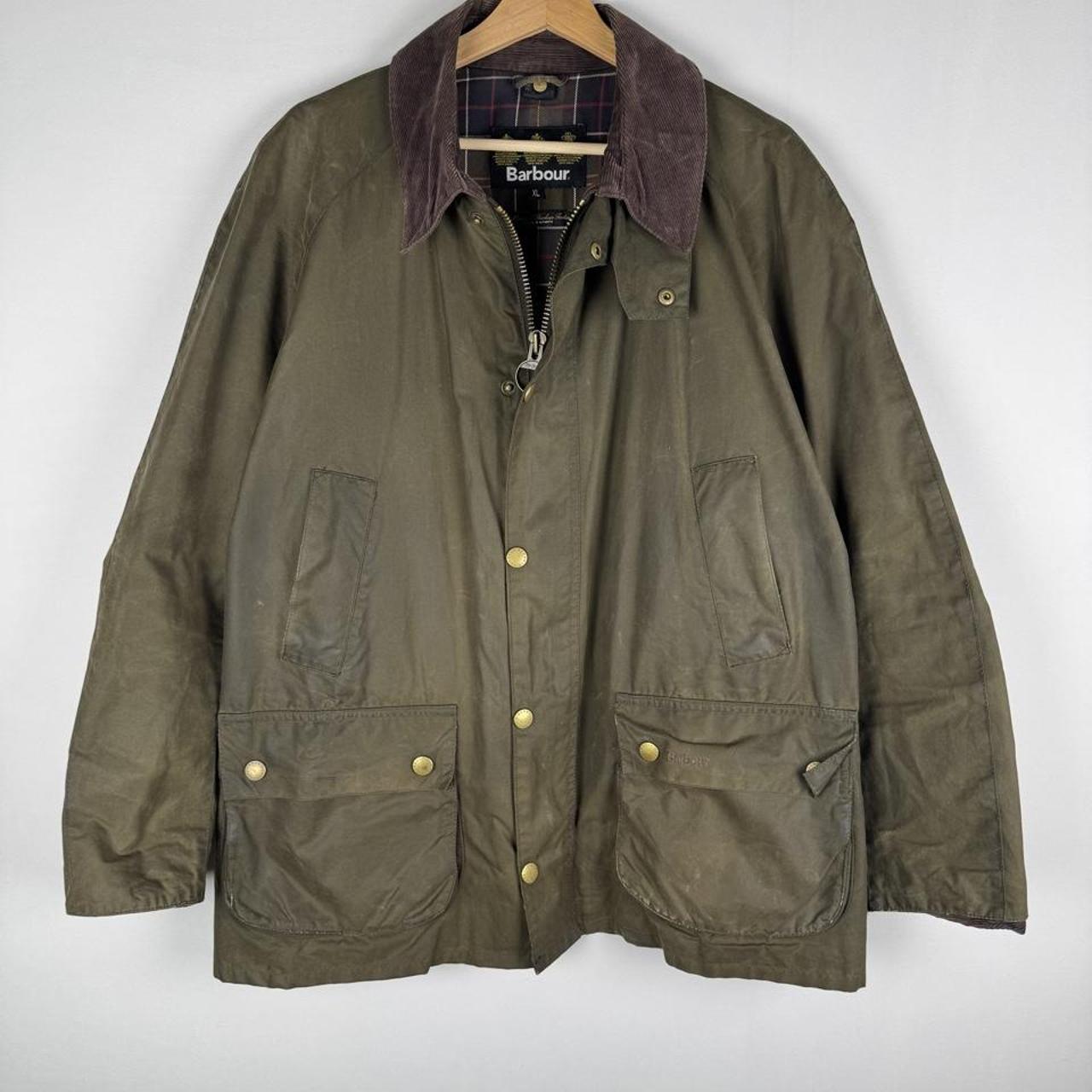 Barbour green wax jacket with logo, classic design, and durable material.