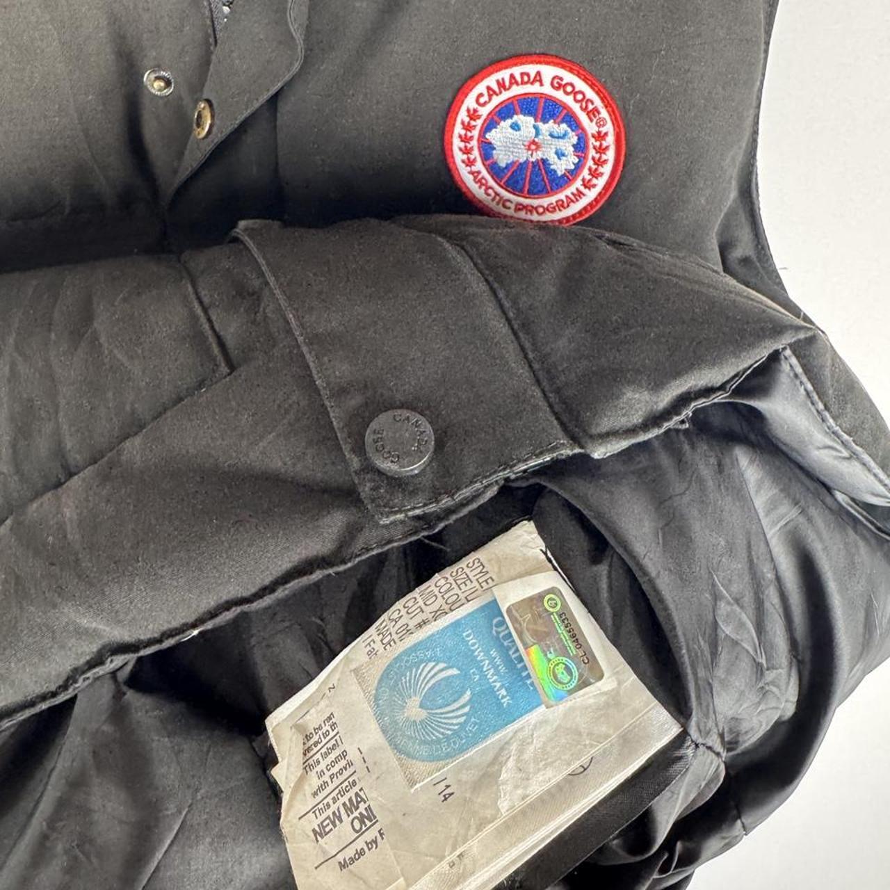 Canada Goose black puffer gilet with logo patch and quilted design.