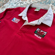 Wales red rugby polo shirt with embroidered logo and World Cup details.