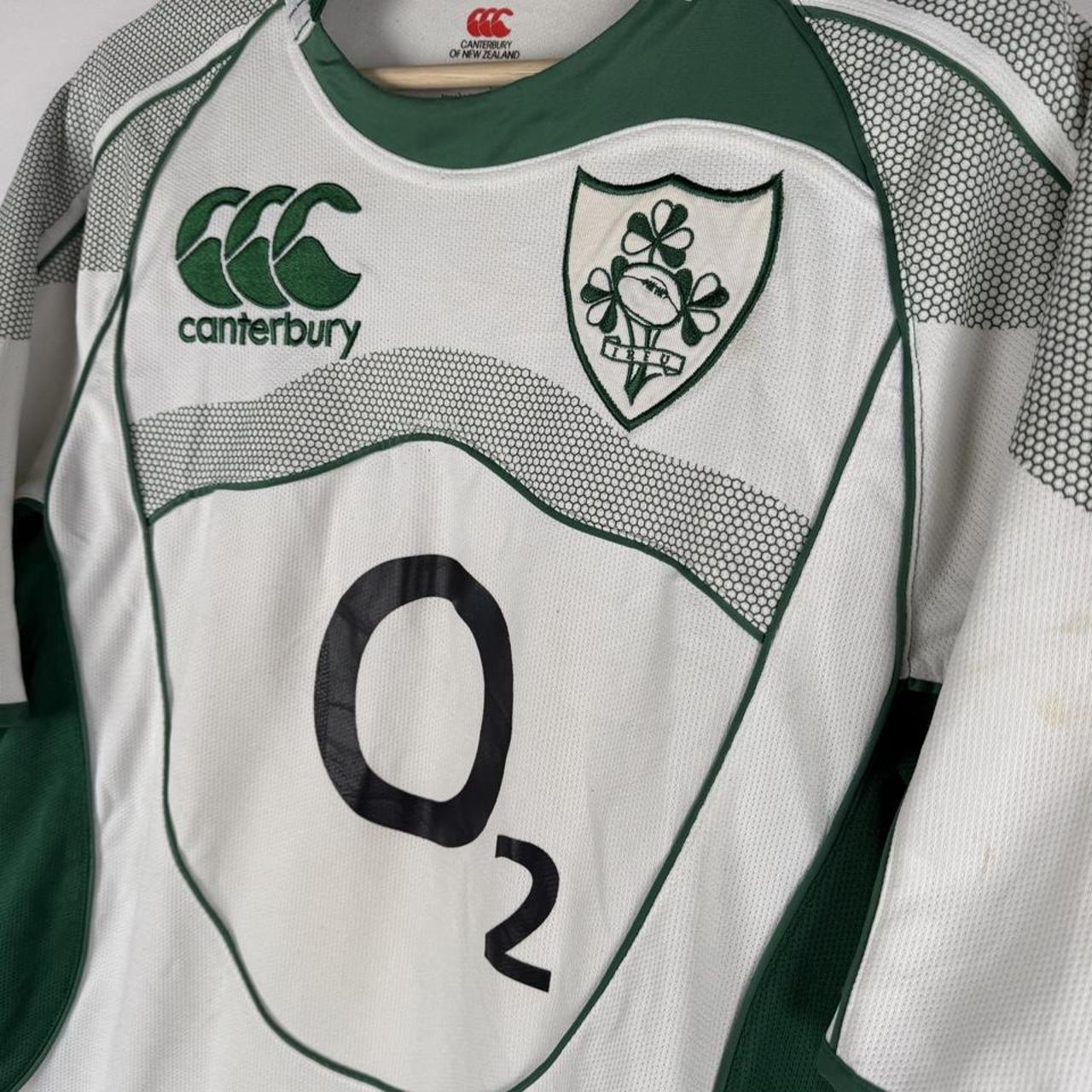 Canterbury green rugby shirt with embroidered Ireland logo and classic collar design.