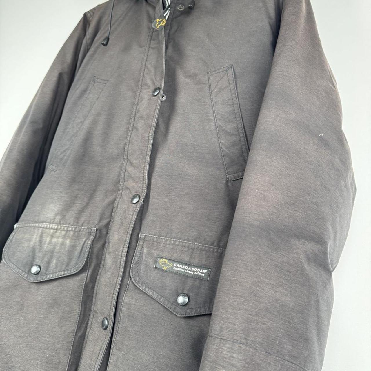 Canada Goose cream parka jacket with logo patch and slightly faded finish.