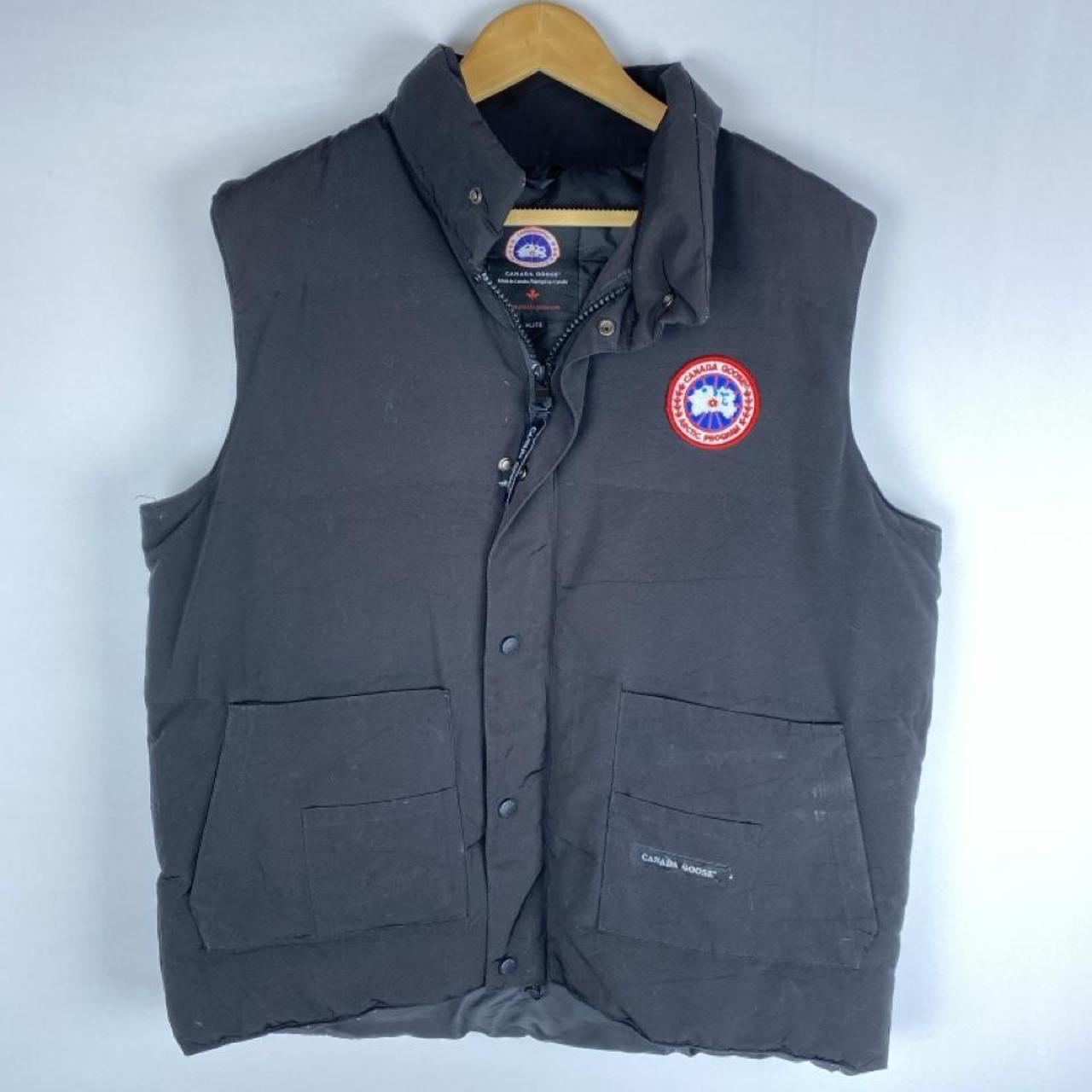 Canada Goose black down filled gilet with logo patch and zippered pockets.