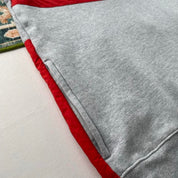 Stüssy grey sweatshirt featuring international logo and soft cotton material.