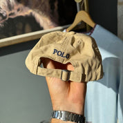 Polo Ralph Lauren beige cap with embroidered pony logo and adjustable strap.