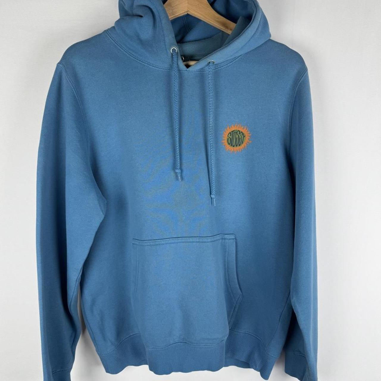 Stüssy graphic hoodie in grey with colorful sun print and logo detail.