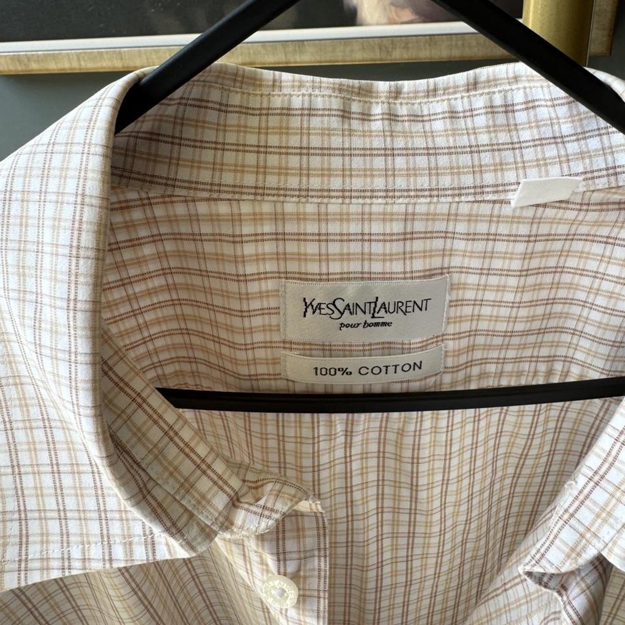 Yves Saint Laurent cream short sleeve shirt with embroidered YSL logo and button details.