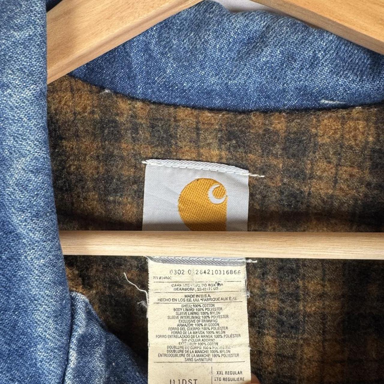 Carhartt denim trucker jacket 1990s style with classic logo and relaxed fit.