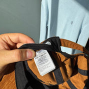 Carhartt WIP hat brown corduroy with embroidered logo and rugged design.
