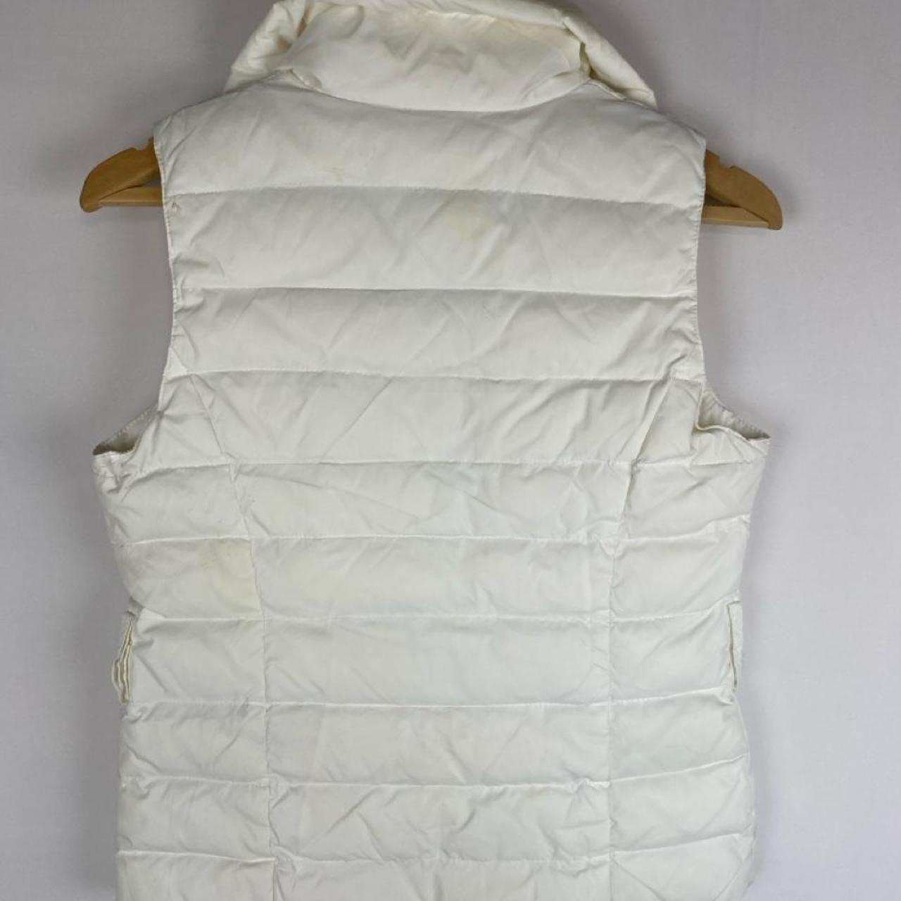 Moncler white down puffer gilet with logo detail and missing belt.