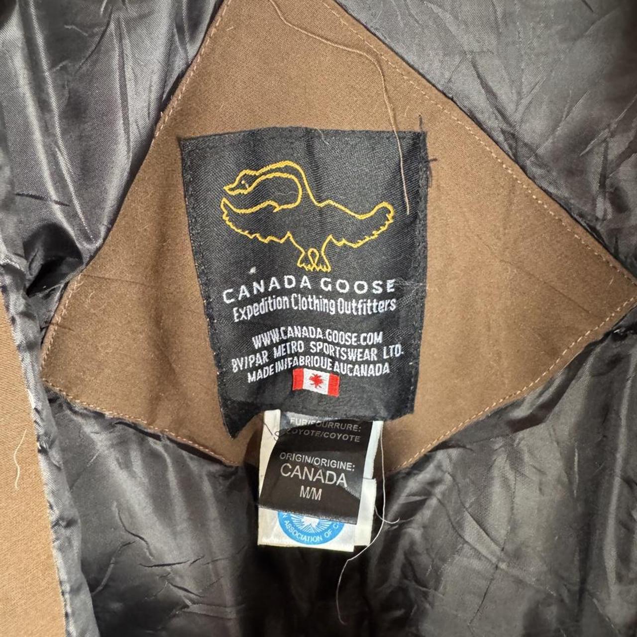 Canada Goose brown parka jacket with utility pockets and logo patch.