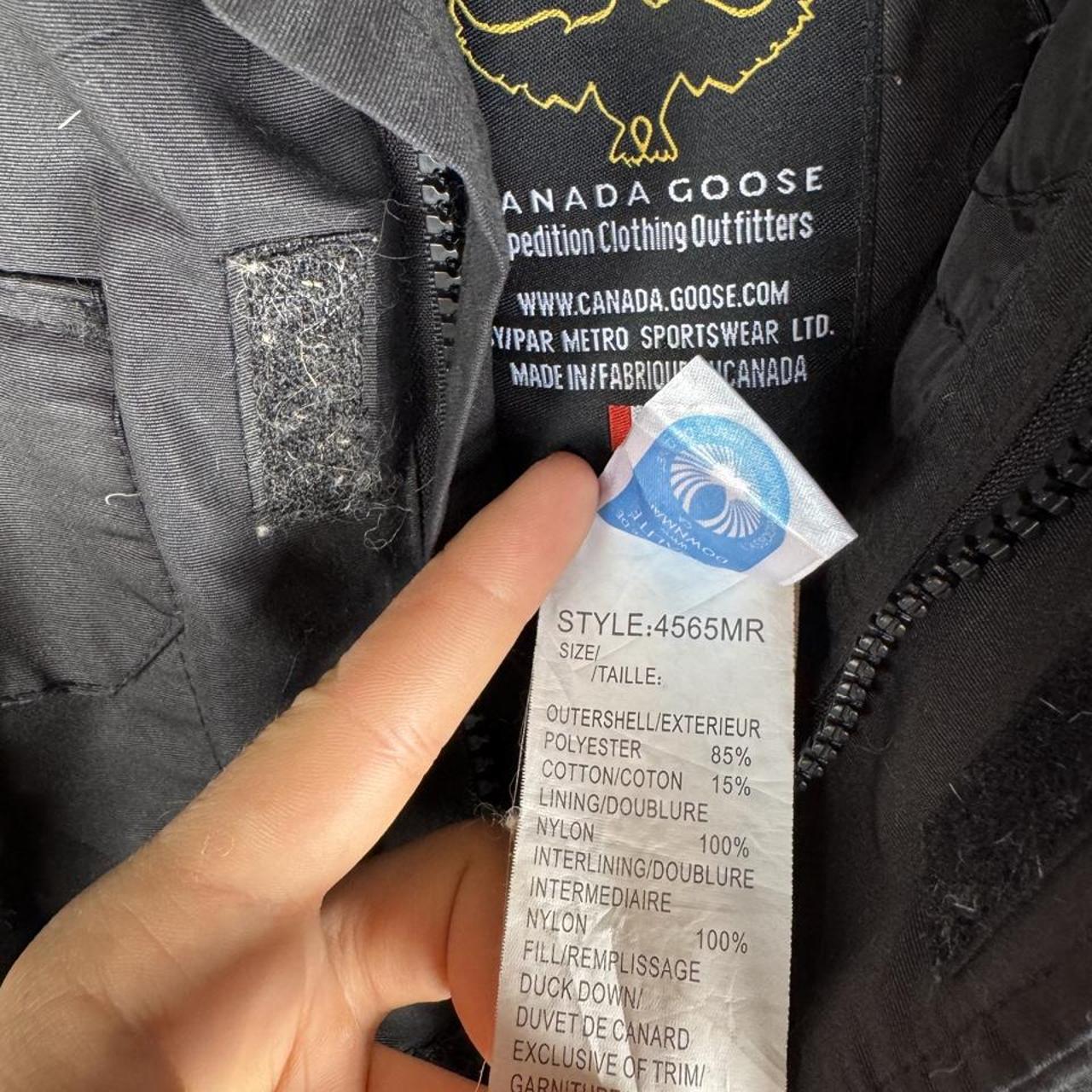 Canada Goose black and brown parka jacket with logo and utility pockets.
