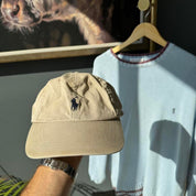 Polo Ralph Lauren tan cap with embroidered logo and adjustable strap.