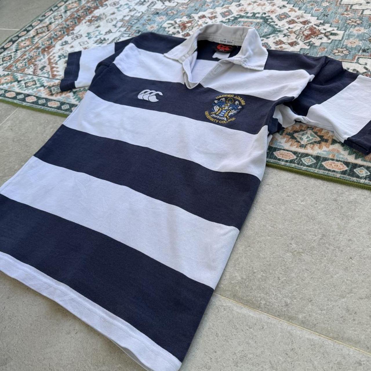 Canterbury men's rugby polo shirt, navy blue, featuring Harper Adams University logo and classic collar.
