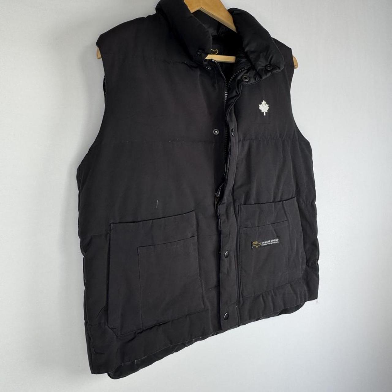 Canada Goose black down filled gilet with logo patch and zip pockets.