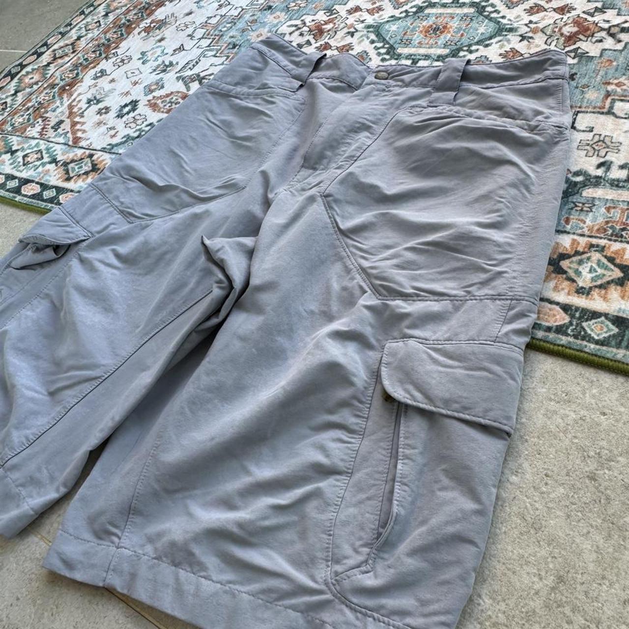 Nike ACG grey cargo shorts with multiple pockets and logo detail.