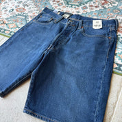Levi's denim 501 shorts blue with classic logo patch and five-pocket design.
