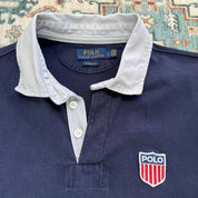 Polo Ralph Lauren navy rugby polo shirt with embroidered logo and thick fabric.