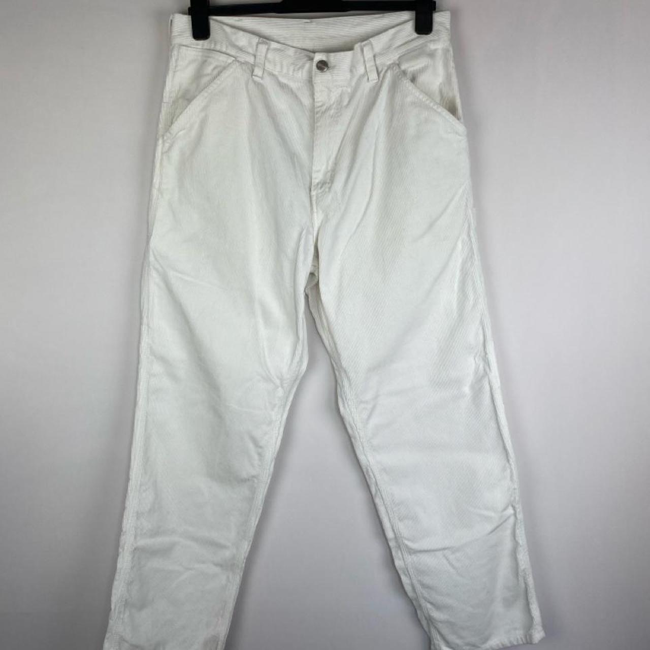 Carhartt WIP white corduroy carpenter trousers with single knee design and relaxed fit.
