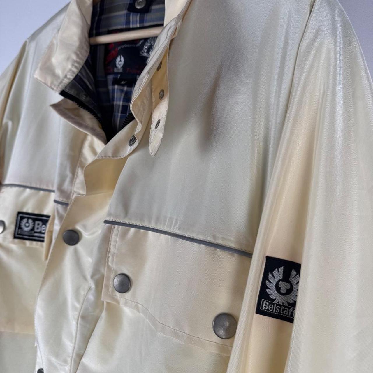 Belstaff cream motorcycle jacket with logo patch and shell material details.