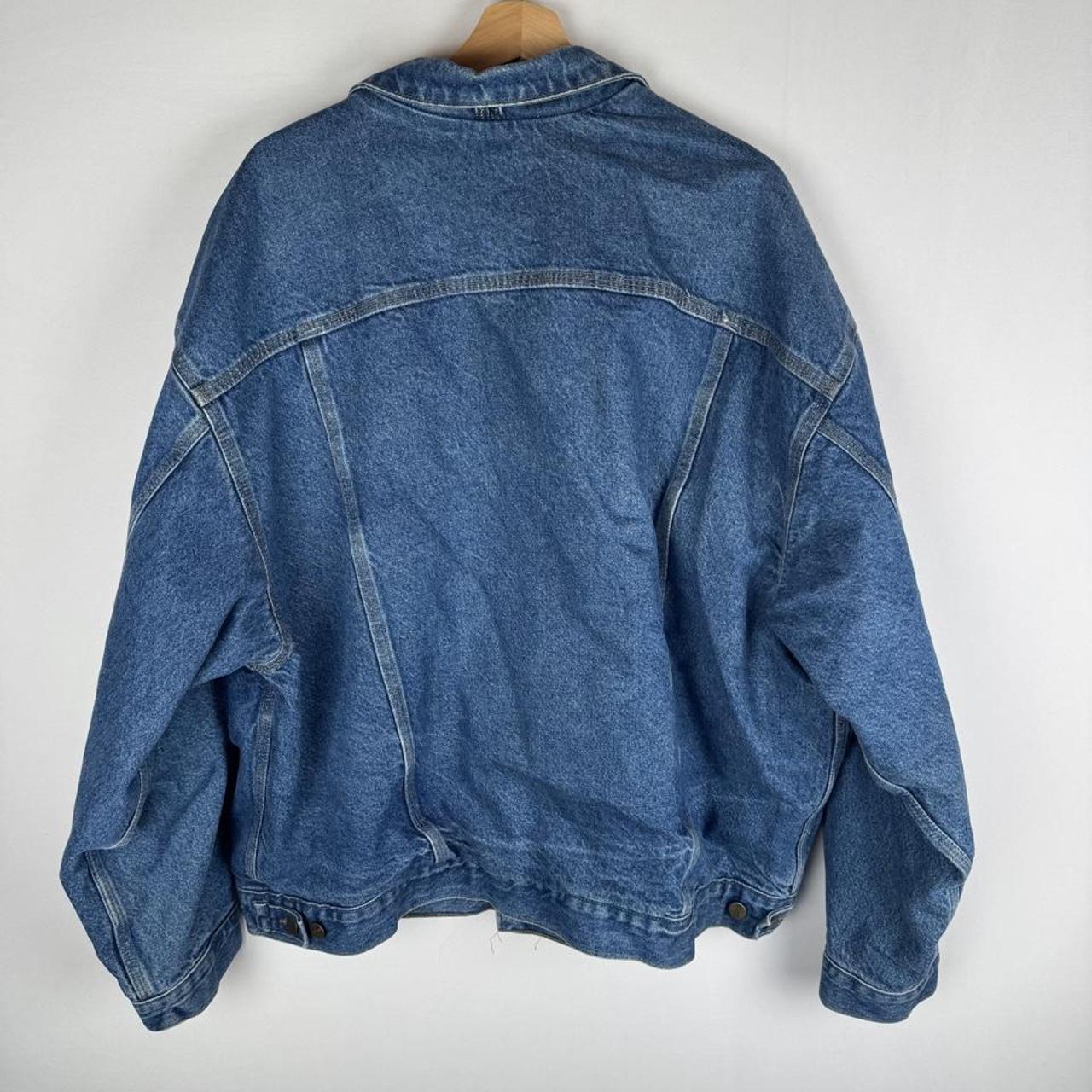 Carhartt denim trucker jacket 1990s style with classic logo and relaxed fit.