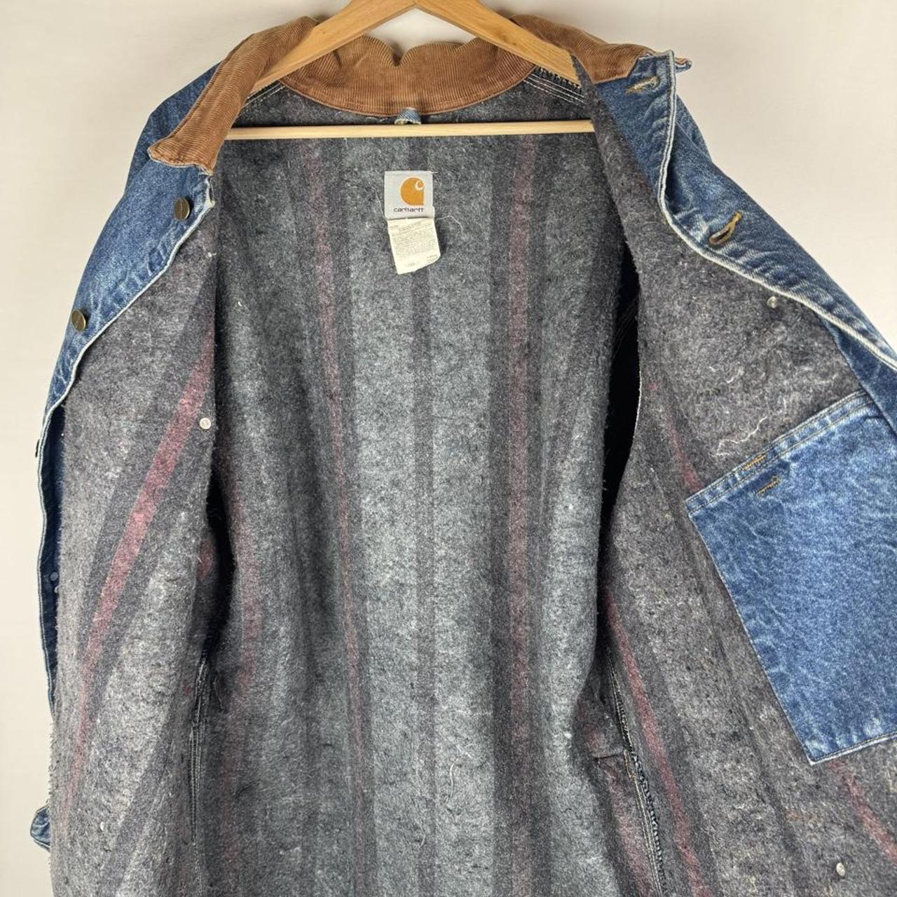 Carhartt denim chore jacket oversized 1990s style with classic logo and blue wash.