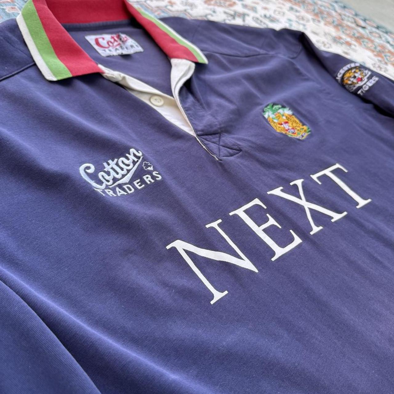 Cotton Traders men's rugby polo shirt, navy with fading, featuring Tigers logo and cotton material.