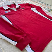 Wales red rugby polo shirt with embroidered logo and World Cup details.