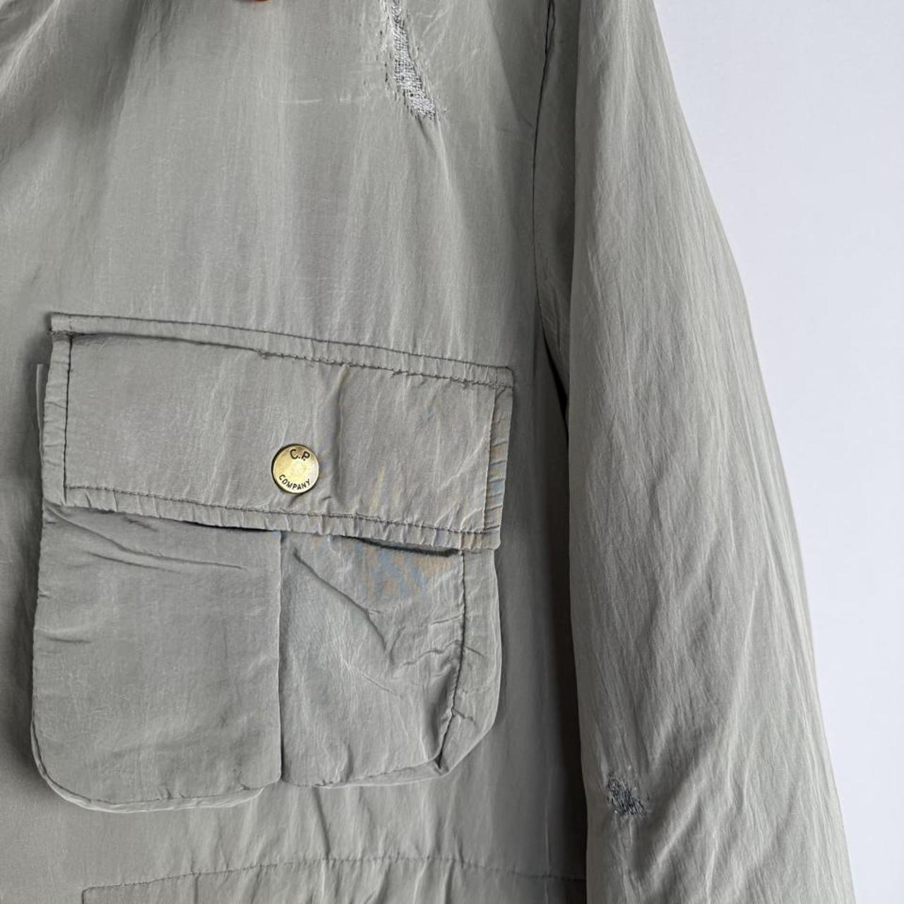 CP Company multi-colour utility parka jacket with multiple pockets and hood.