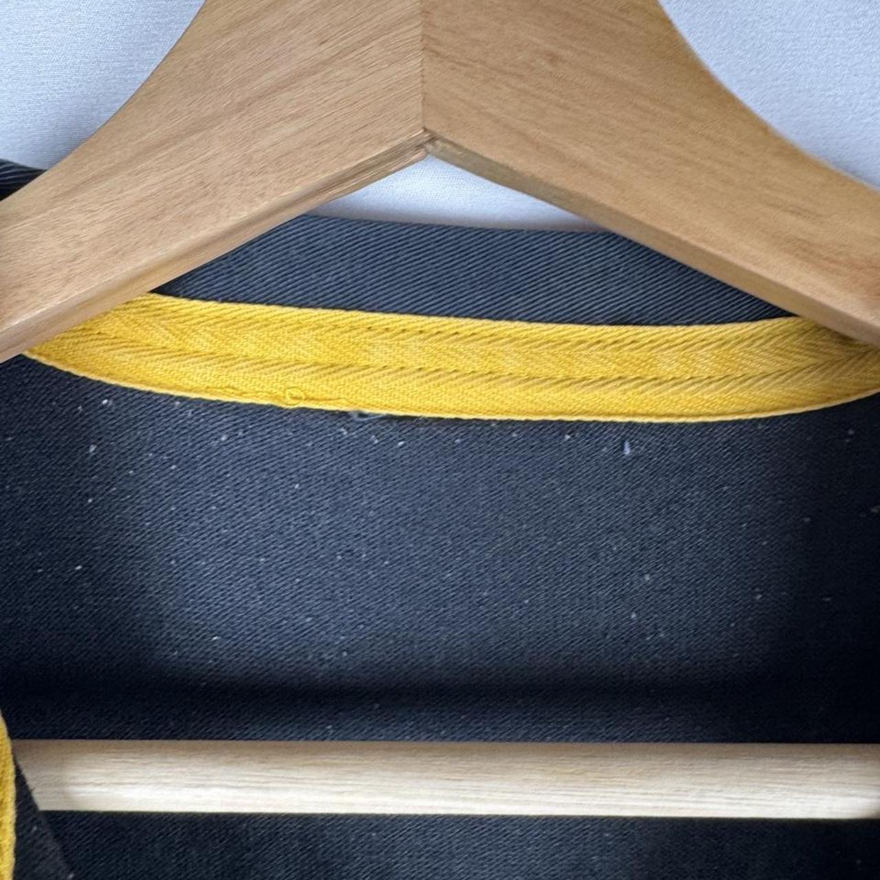 Canterbury men's rugby polo shirt, black and gold, featuring Wasps logo and classic design.