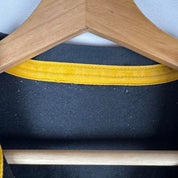 Canterbury men's rugby polo shirt, black and gold, featuring Wasps logo and classic design.
