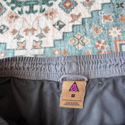 Nike ACG grey cargo training shorts with multiple pockets and logo detail.