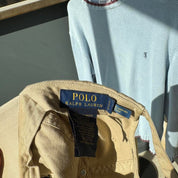 Polo Ralph Lauren beige cap with embroidered pony logo and adjustable strap.