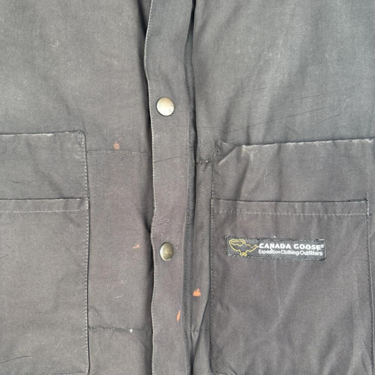 Canada Goose black down puffer gilet with logo patch and quilted texture.